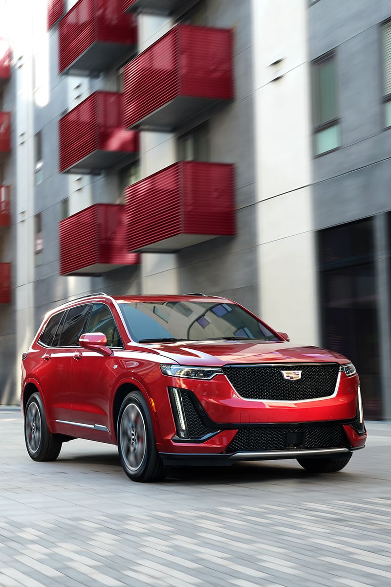 2023 XT6 Mid-Size 7 Passenger SUV parked outside a building.