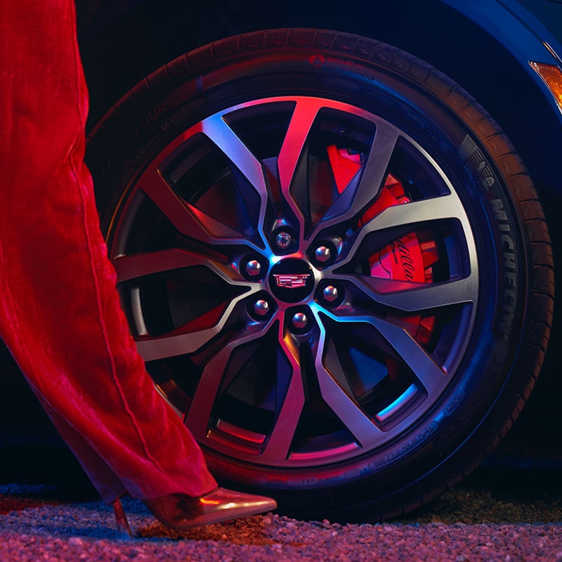 Alloy wheel close-up of the 2024 Cadillac XT5 at night.