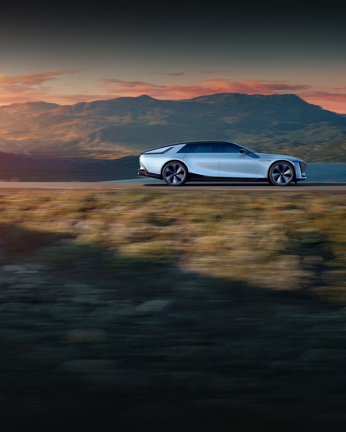 Side view of the 2025 Cadillac CELESTIQ driving fast on a hillside road.