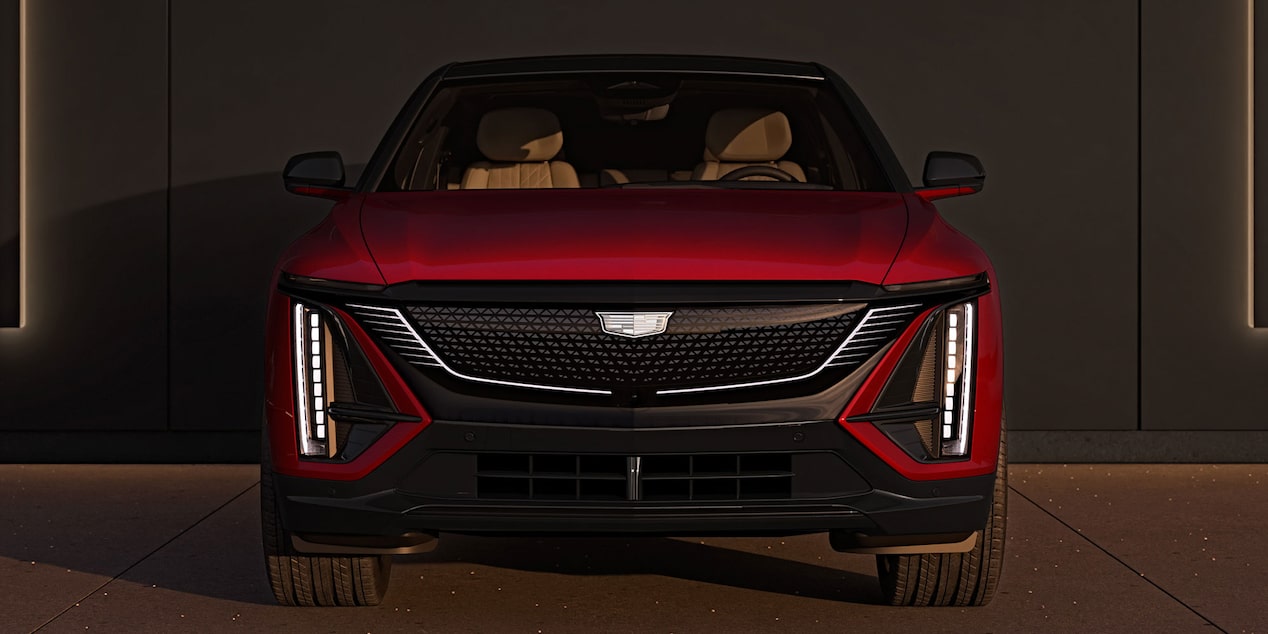 Front view of the 2025 Cadillac LYRIQ Sport trim parked outside a garage.