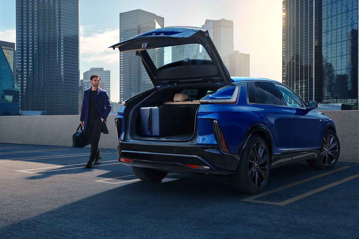 The trunk of the 2025 Cadillac LYRIQ opened as a person passes by.