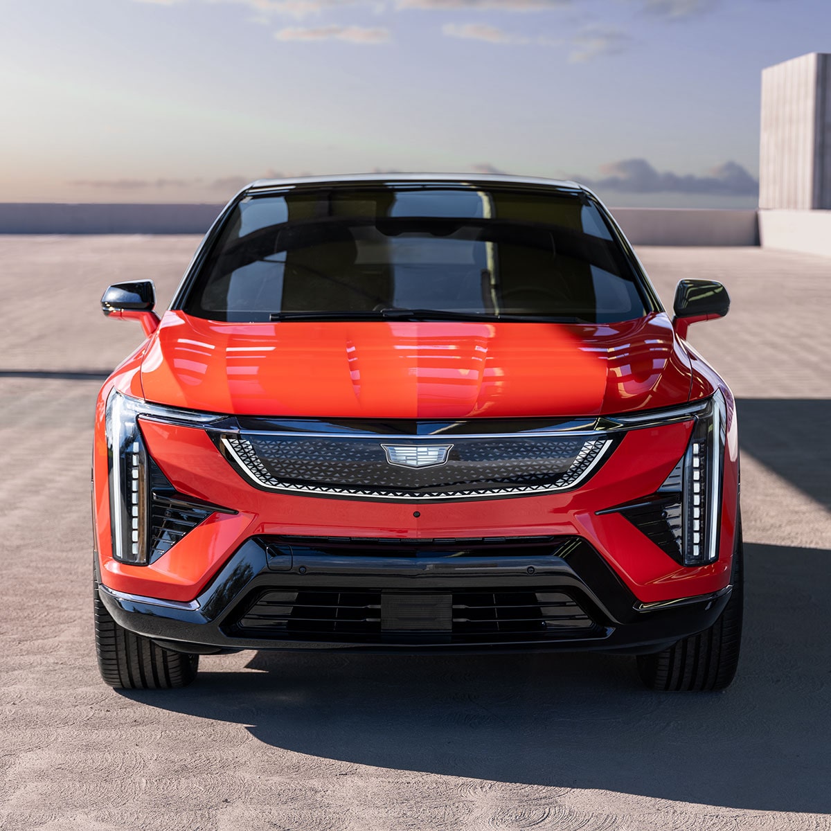 Front profile of the 2025 Cadillac OPTIQ electric SUV parked alone in the morning.
