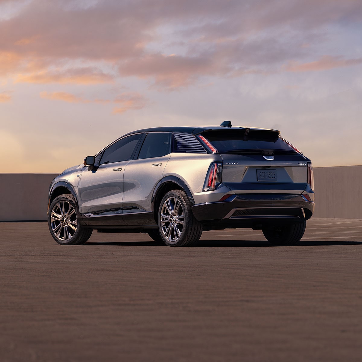 2025 Cadillac OPTIQ electric SUV parked outdoors during sunset.
