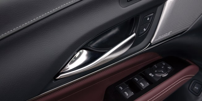 Close-up view of the door handle and automatic window control of the CT4.