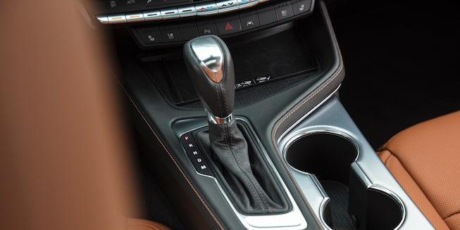 2020 Cadillac CT4 interior: gear stick and cup holders.