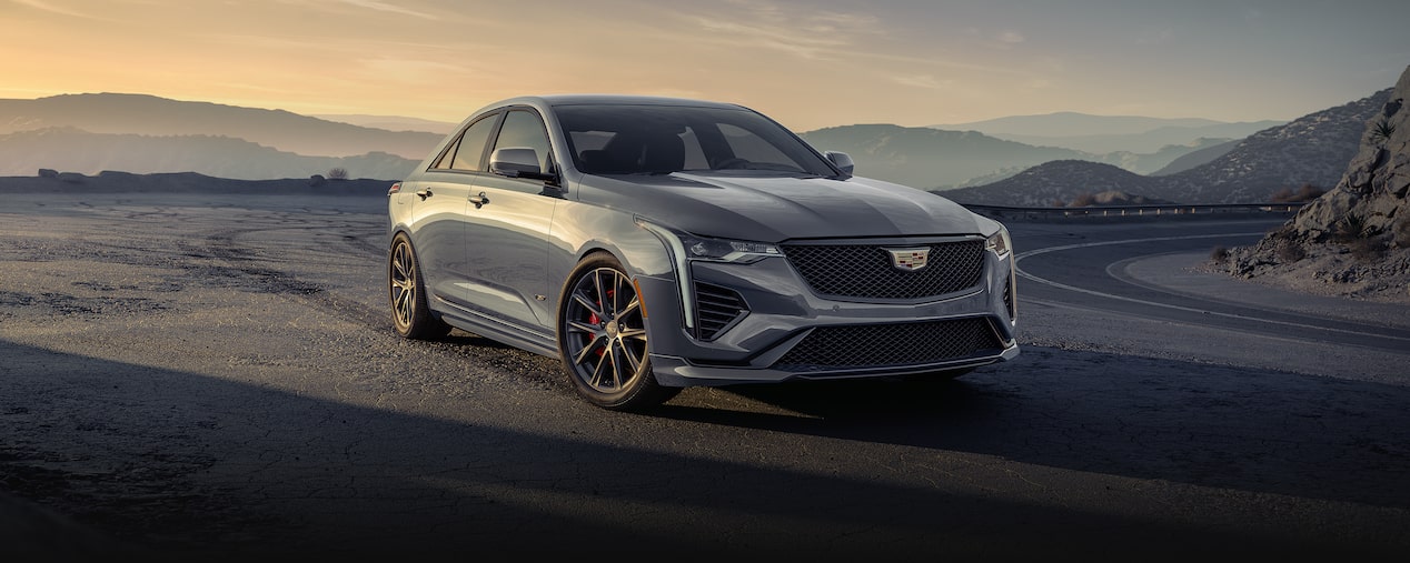 2025 Cadillac CT4-V luxury sports sedan driving alone on a hillside road.