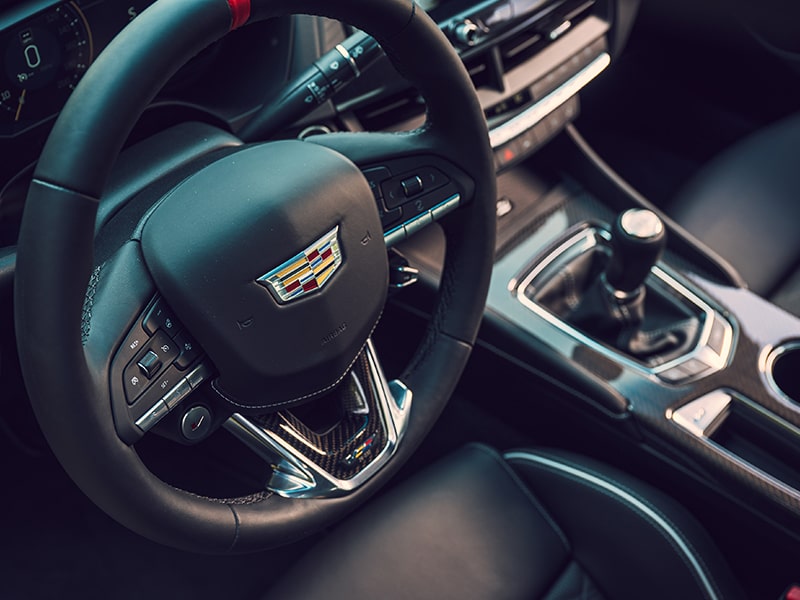 Top view of the thick-rimmed steering wheel on the 2025 Cadillac CT4-V luxury sports sedan.