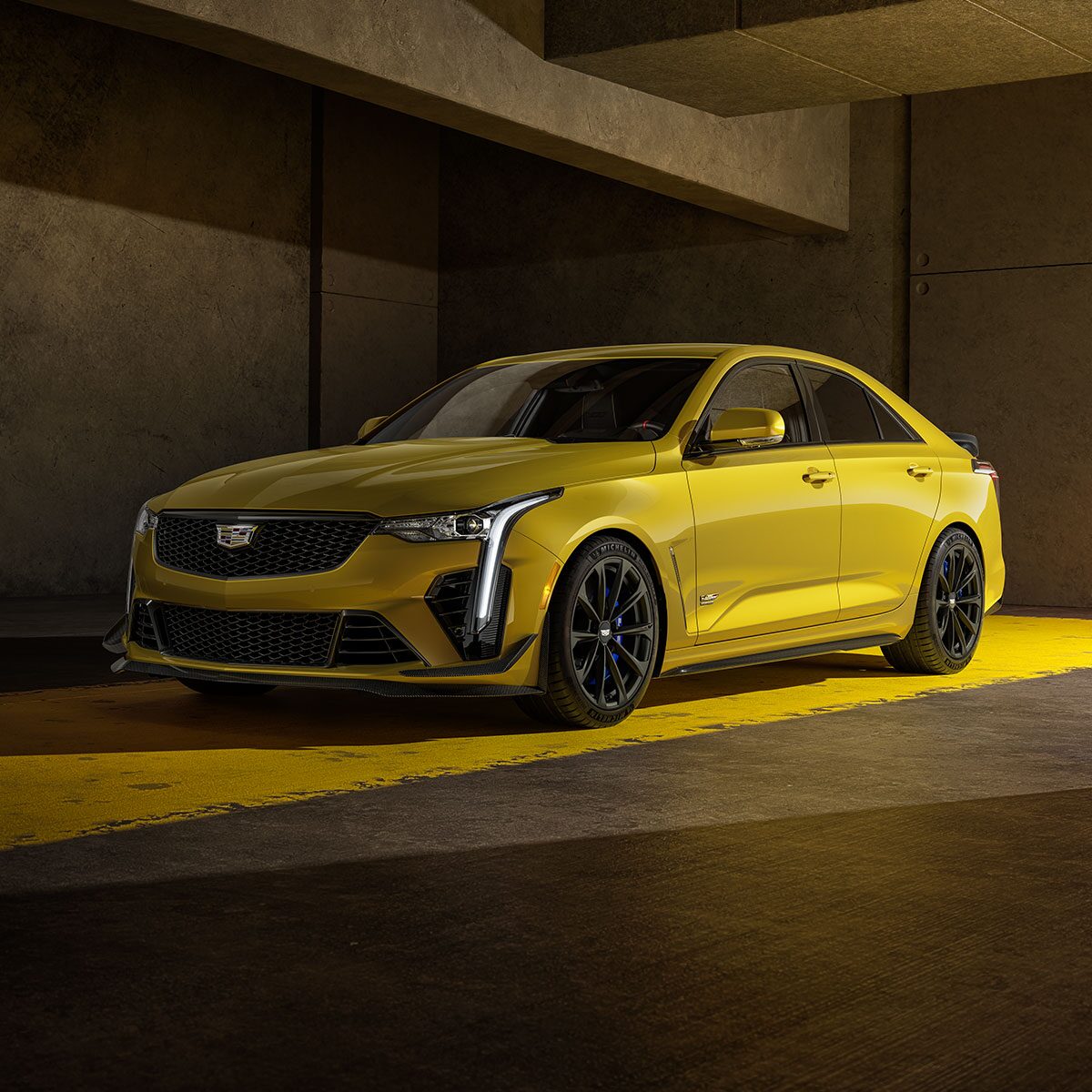 2025 Cadillac CT4-V luxury sports sedan parked alone in a dimly-lit setting.