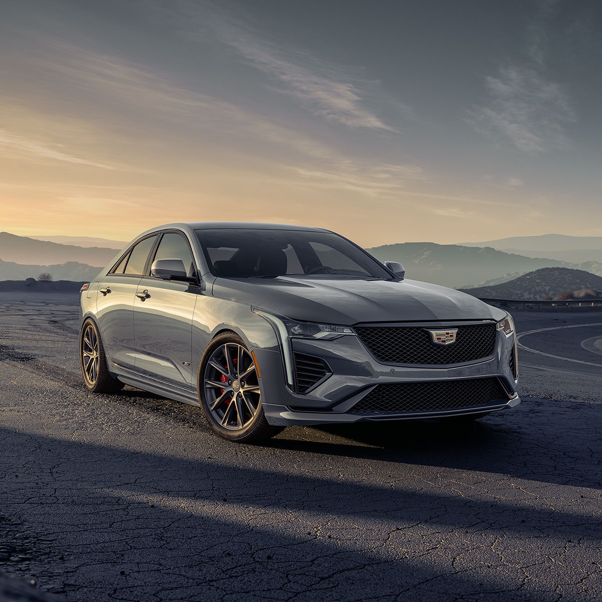 2025 Cadillac CT4-V luxury sports sedan driving durin sunrise.
