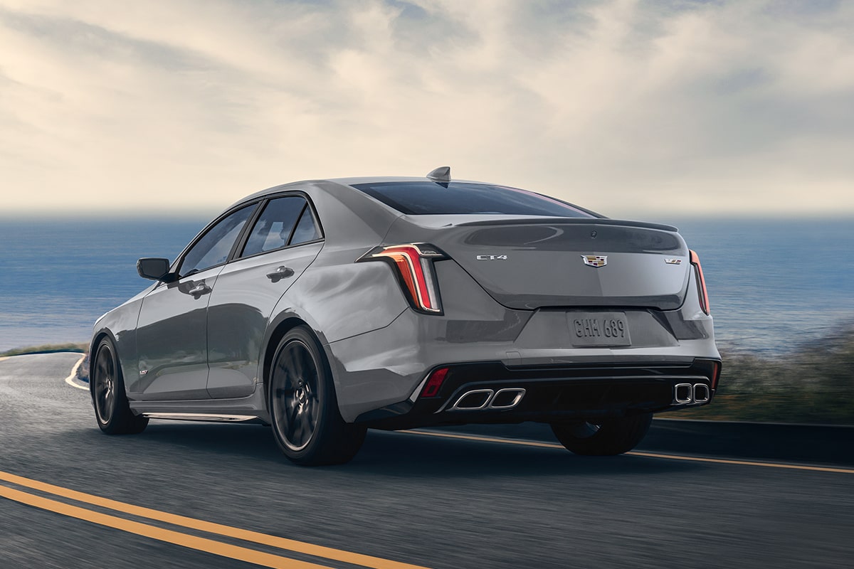2025 Cadillac CT4-V luxury sports sedan driving on a seaside road.
