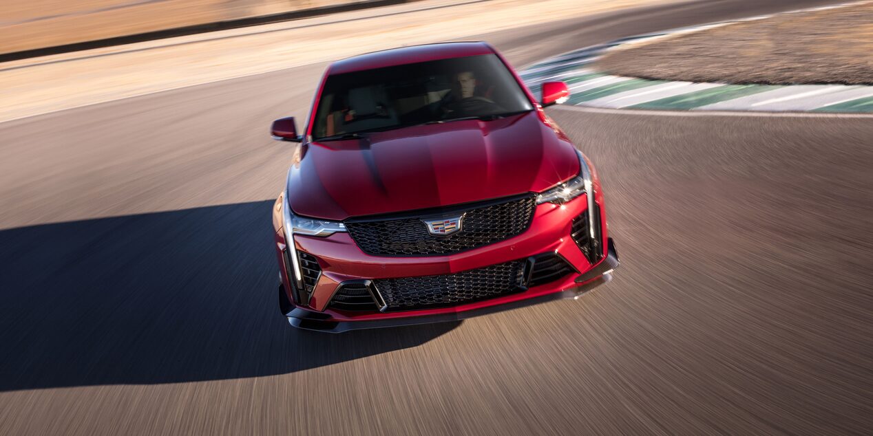 Front view of the 2023 Cadillac CT4-V compact sport sedan driving on a race track.