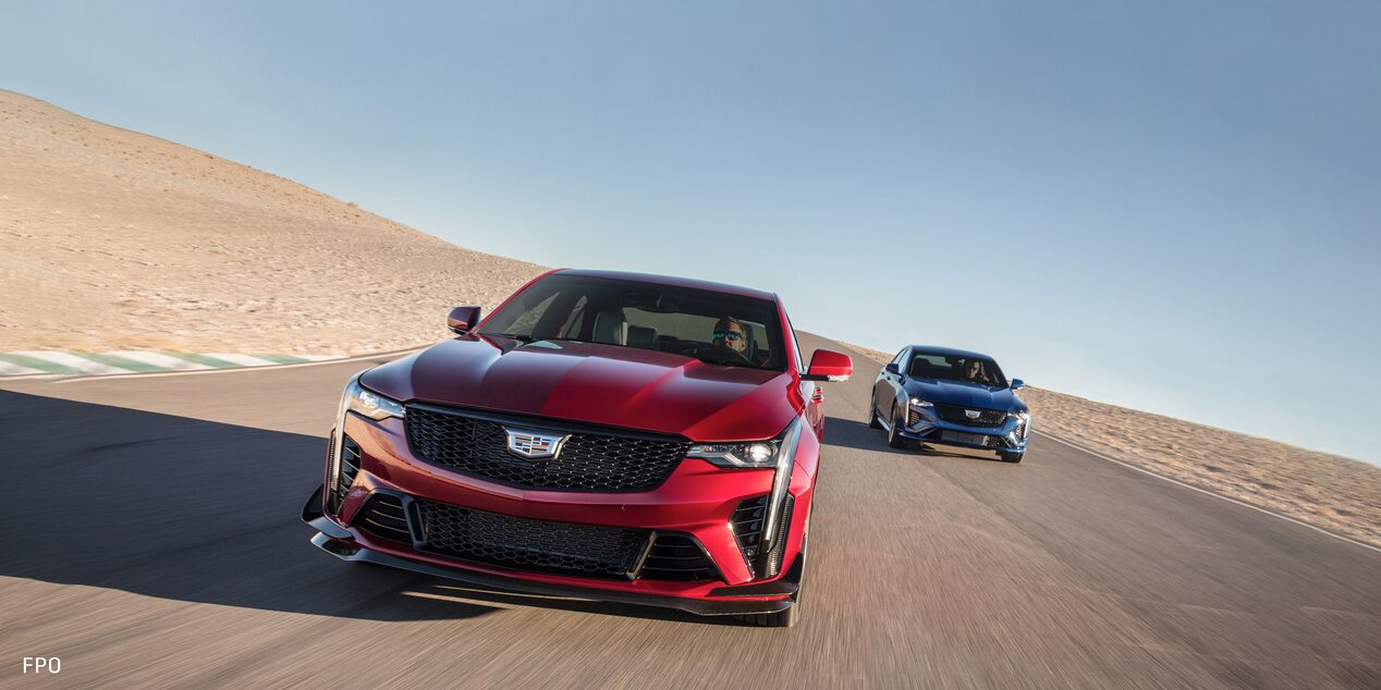 Front view of the 2023 Cadillac CT4-V compact sport sedan driving on a race track.