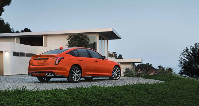 Back view of a 2022 CT5-V parked outside a home.