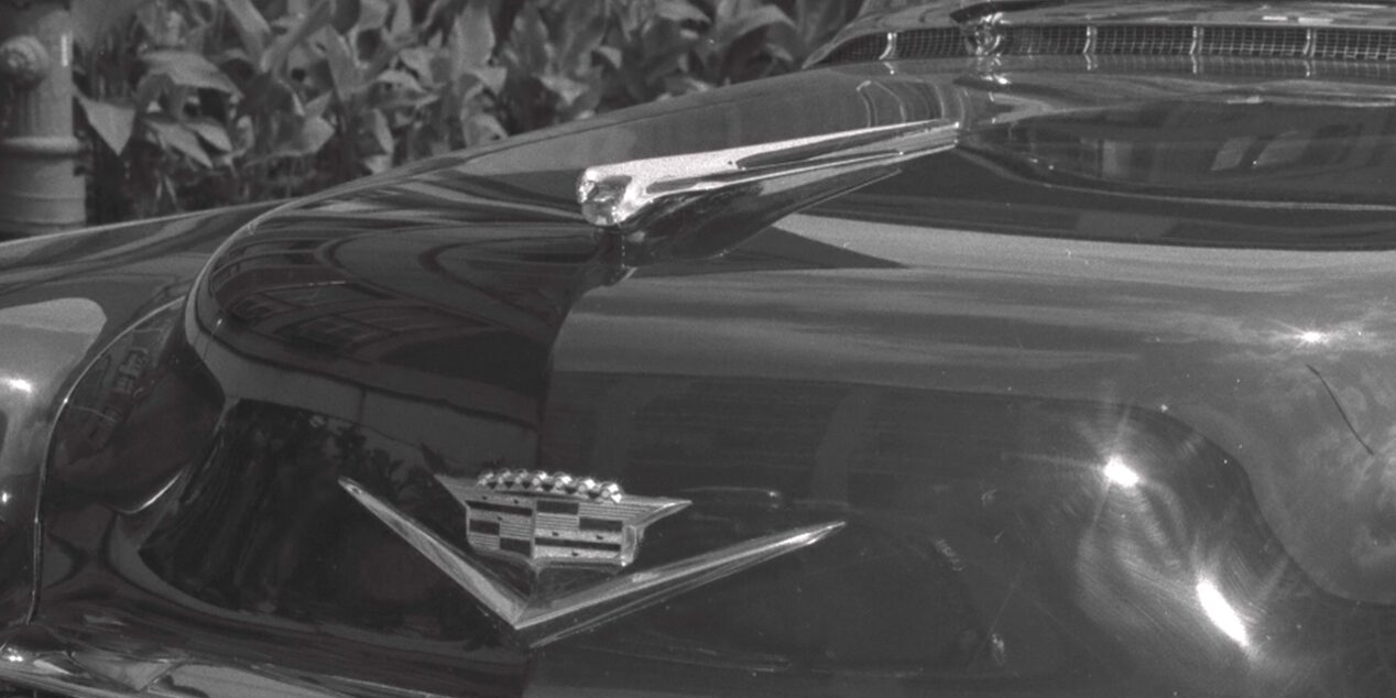 The Cadillac Goddess icon from the 1950s as a stylized, aerodynamic shape.