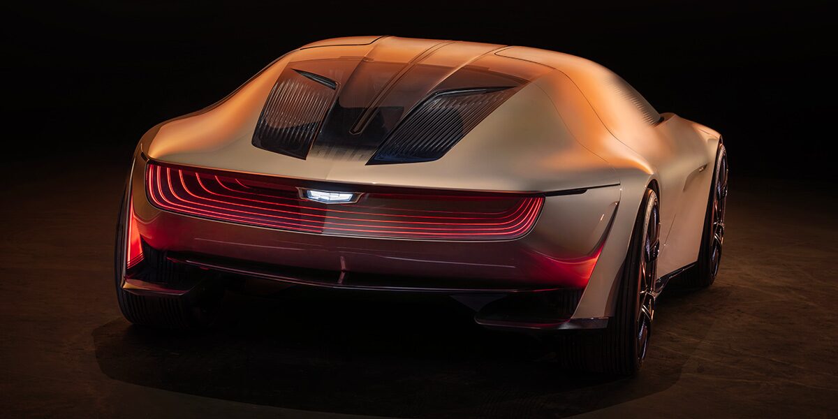 Back view of the Cadillac Opulent Velocity parked in a dim area.