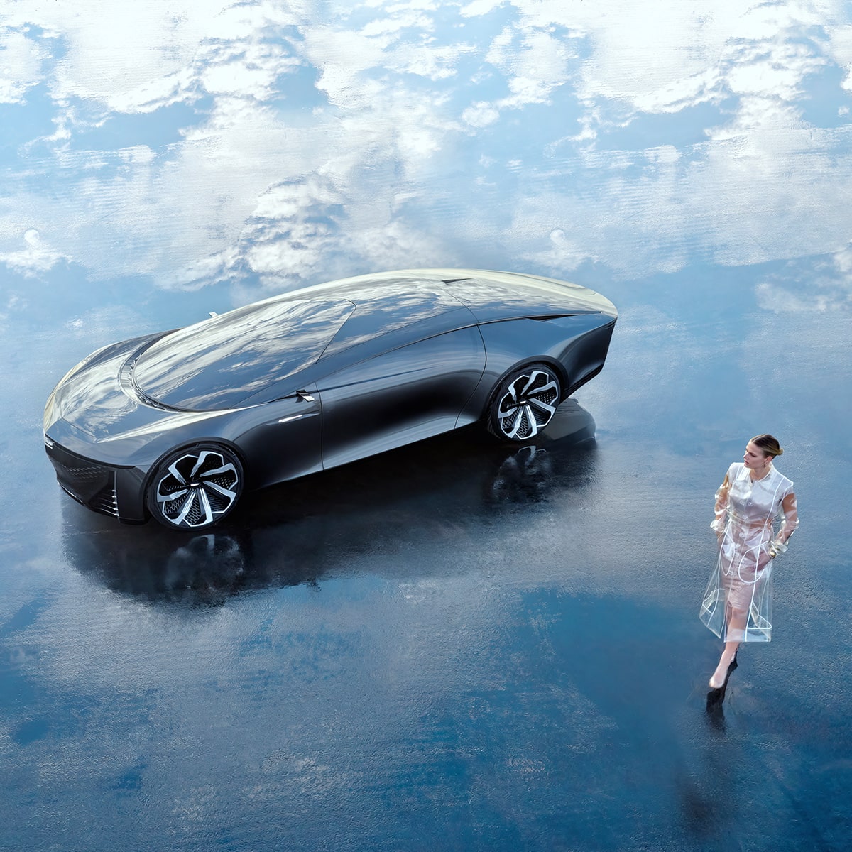 A Cadillac InnerSpace Concept Vehicle parked on a cloudy backdrop as a person passes by.