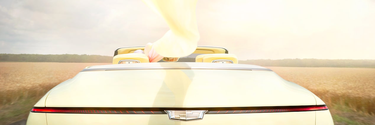 Back view of the Cadillac SOLLEI Concept Vehicle parked outdoors on a sunny day.