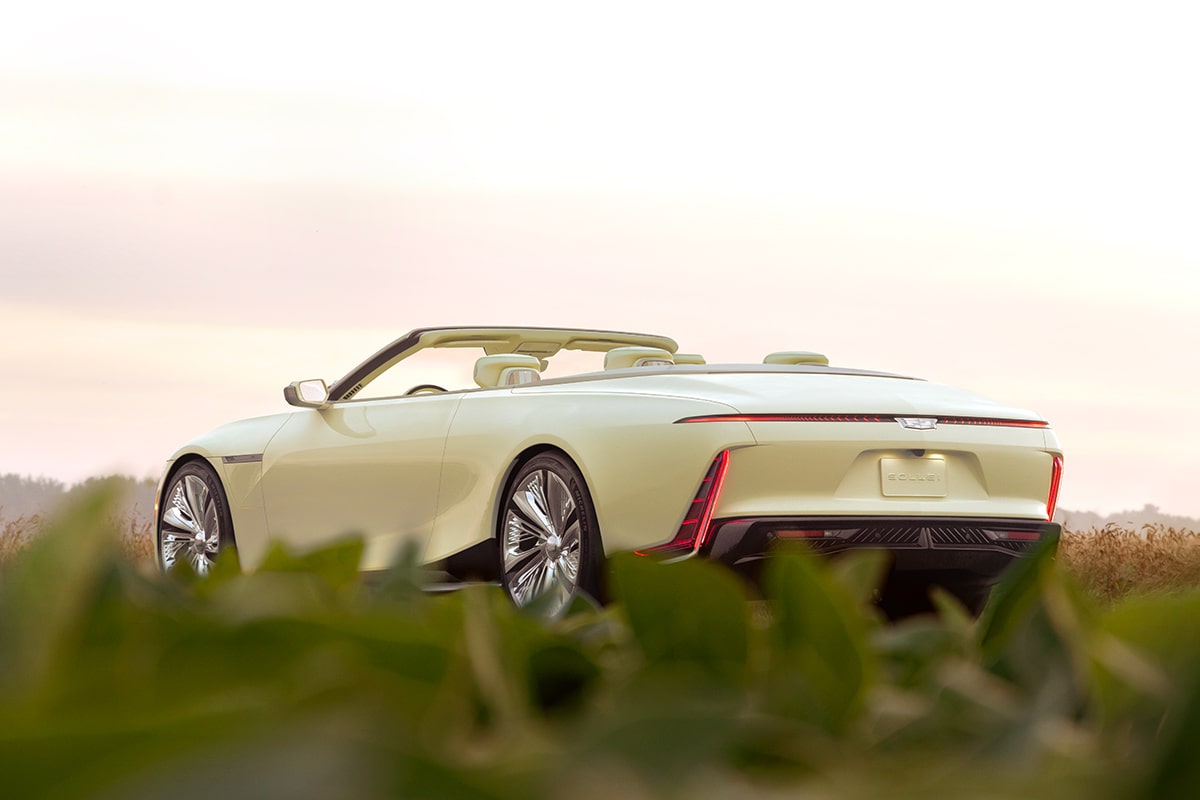 Back-side view of the Cadillac SOLLEI Concept Vehicle parked alone on a grass field.