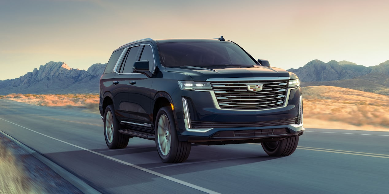 2023 Escalade driving on the road featuring Electronic Limited-Slip Differential.