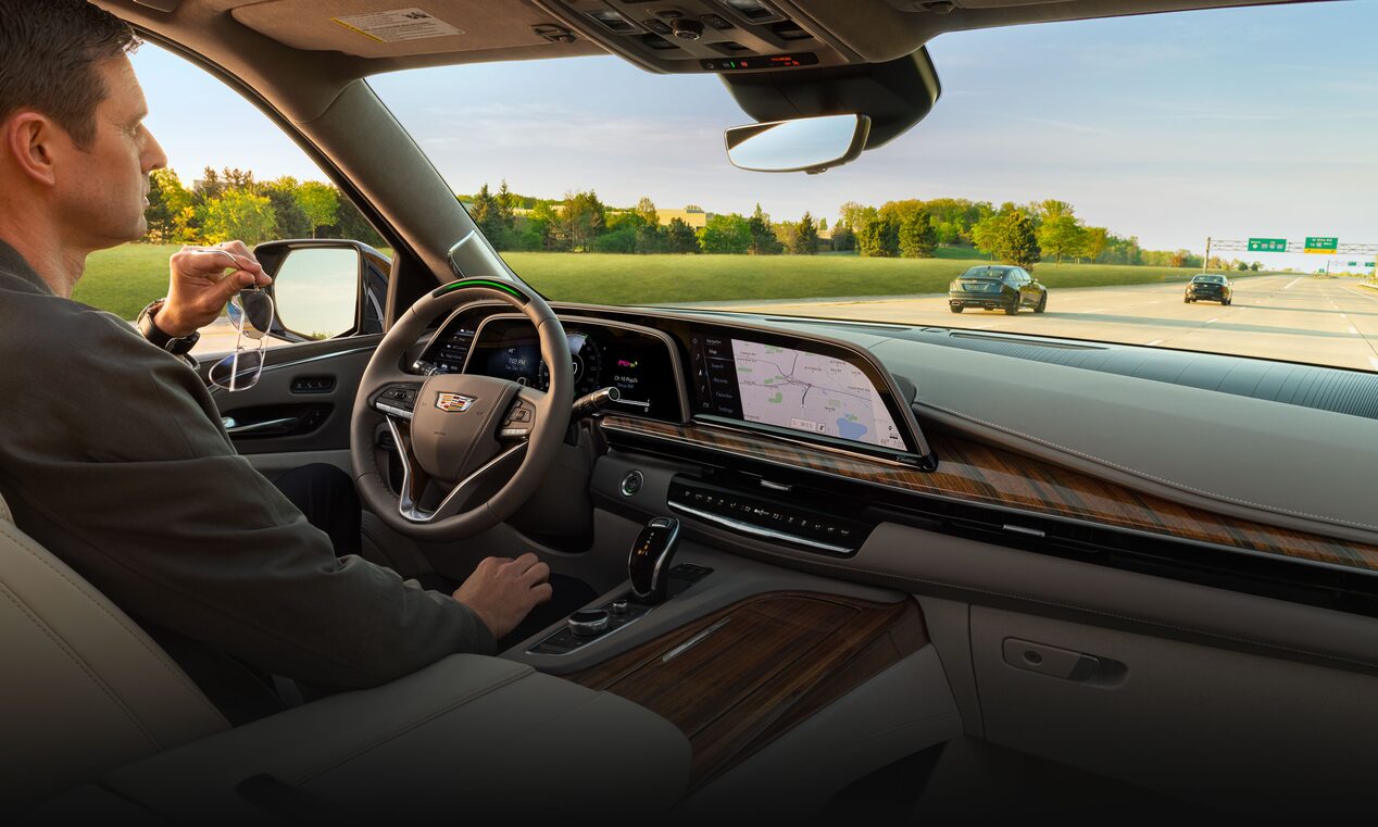 A person driving a 2023 Cadillac Escalade using the Super Cruise feature.