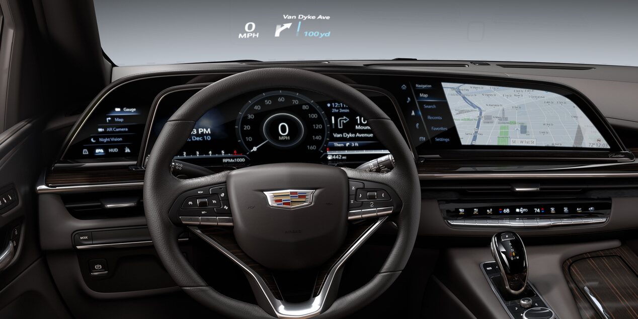 2023 Cadillac Escalade front interior featuring leather seats and dashboard with full colour HUD.