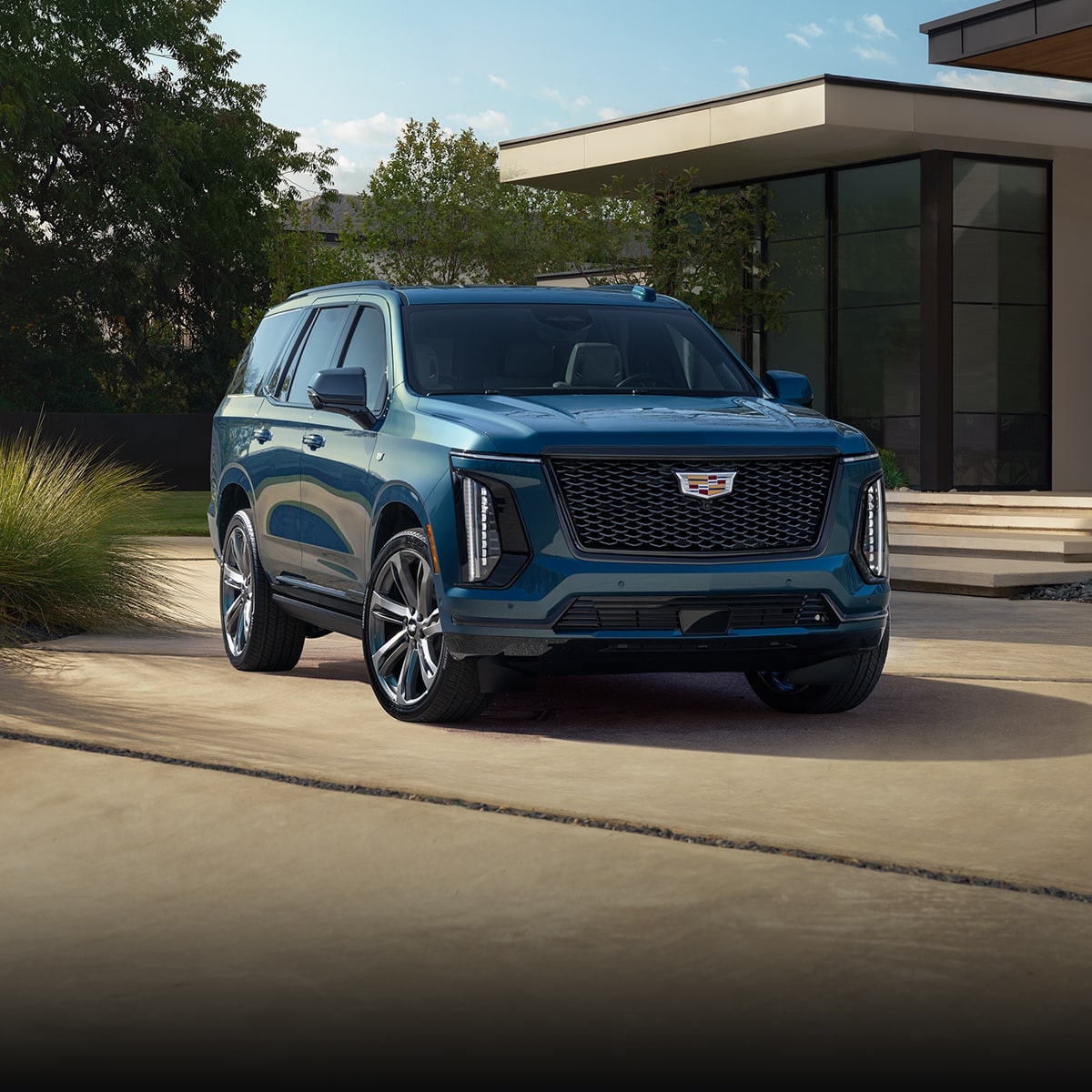 2025 Cadillac Escalade parked outside a house.