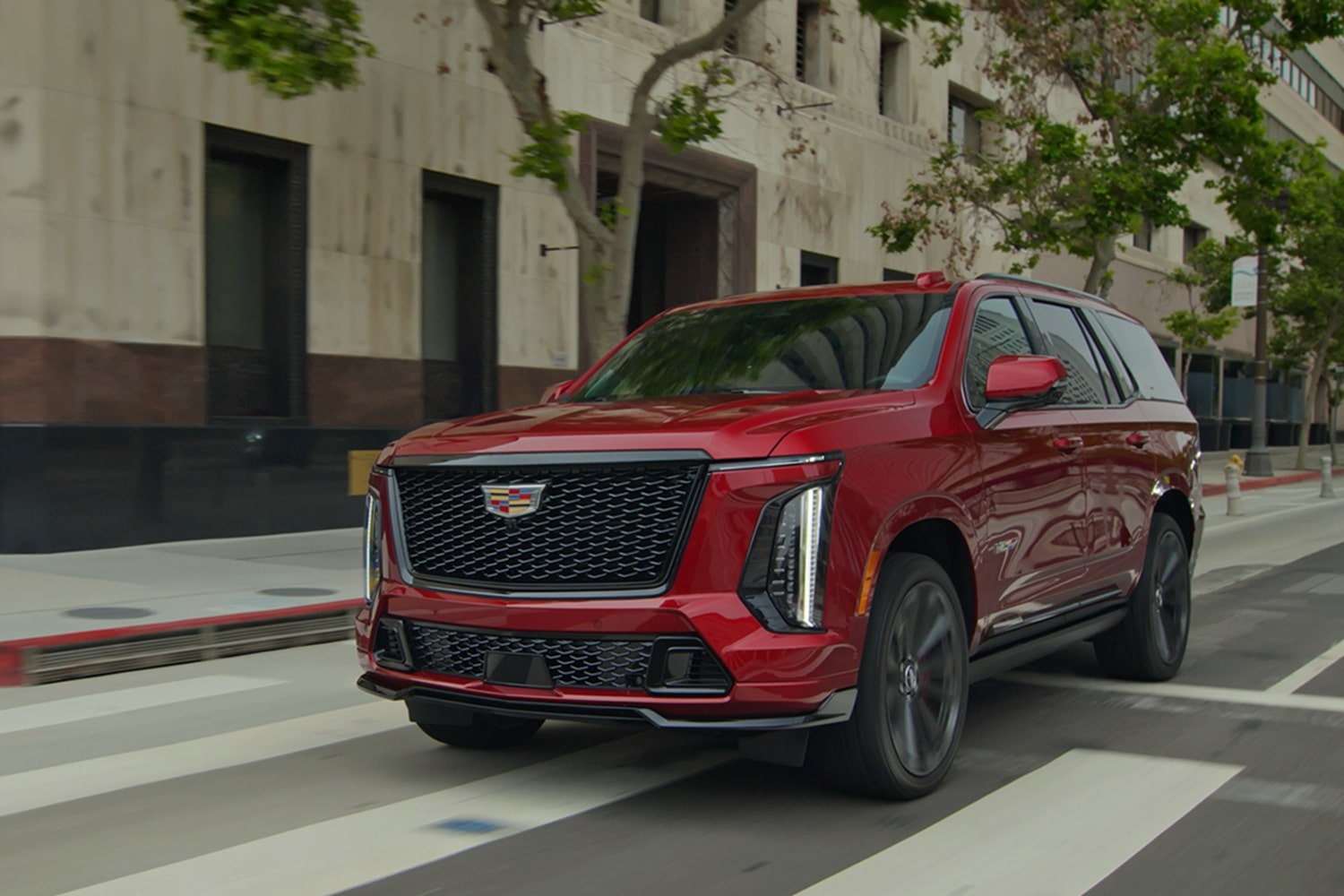 2025 Cadillac Escalade-V driving on a city street.