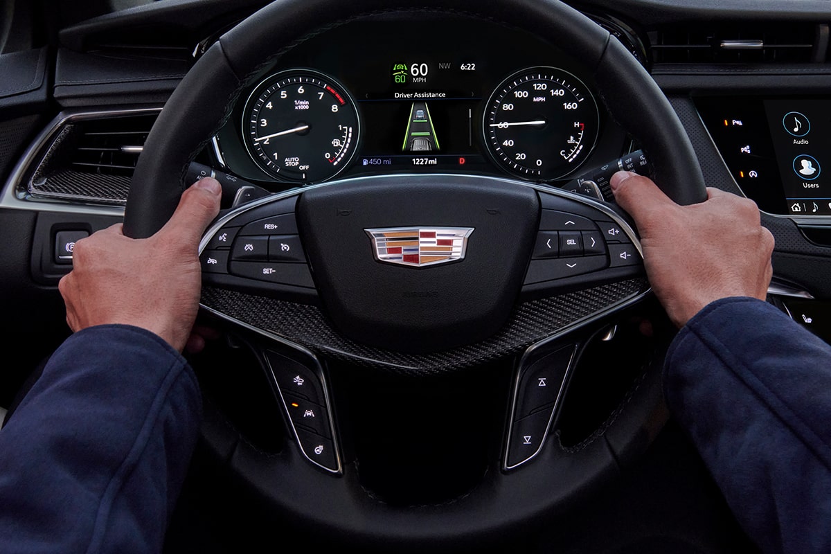 First-person view of a person driving the 2026 Cadillac XT5 luxury SUV.