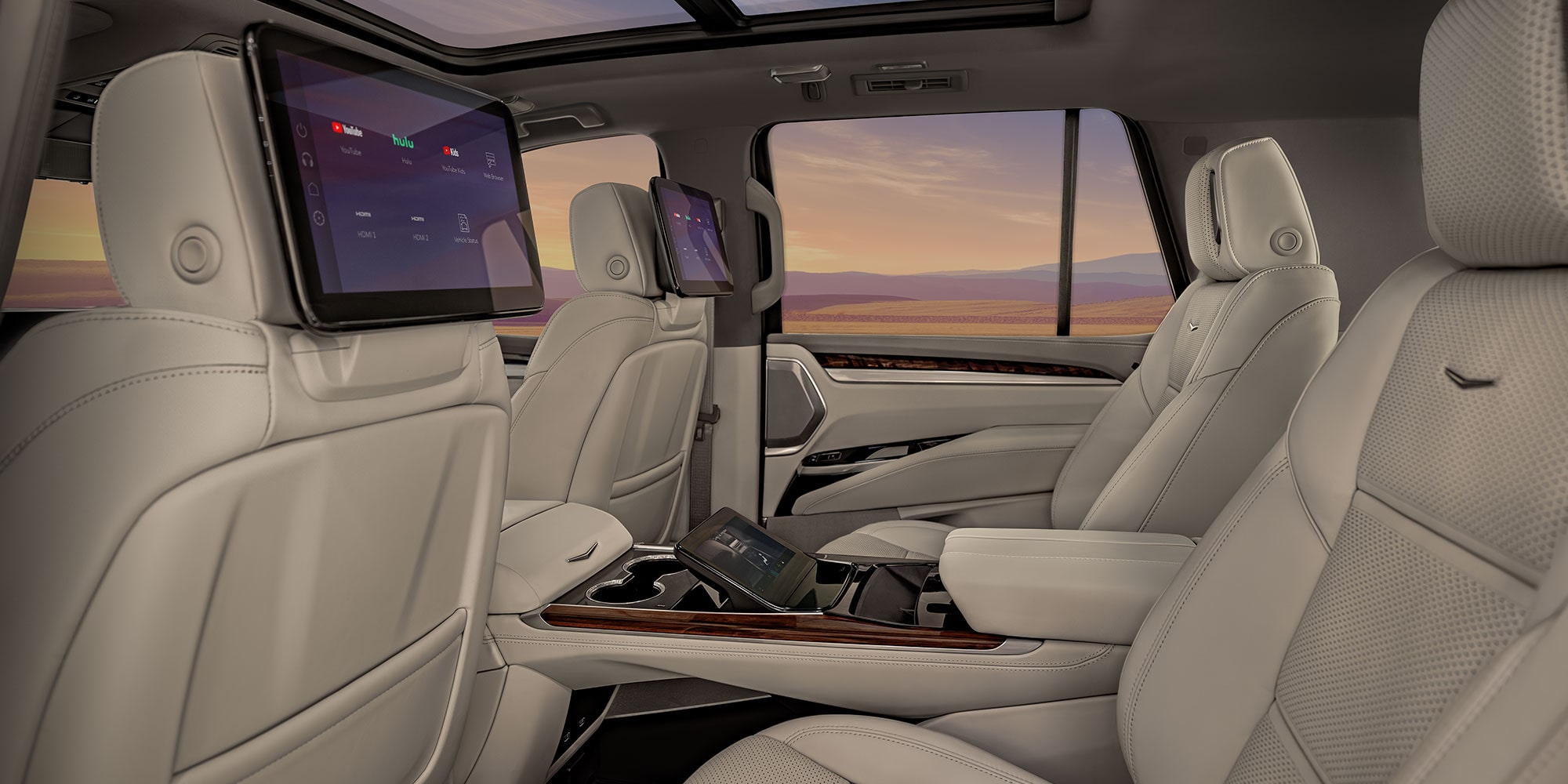 Sièges spacieux de deuxième rangée du Cadillac Escalade 2027 avec écrans de divertissement pour passagers intégrés aux appuie-tête des sièges avant