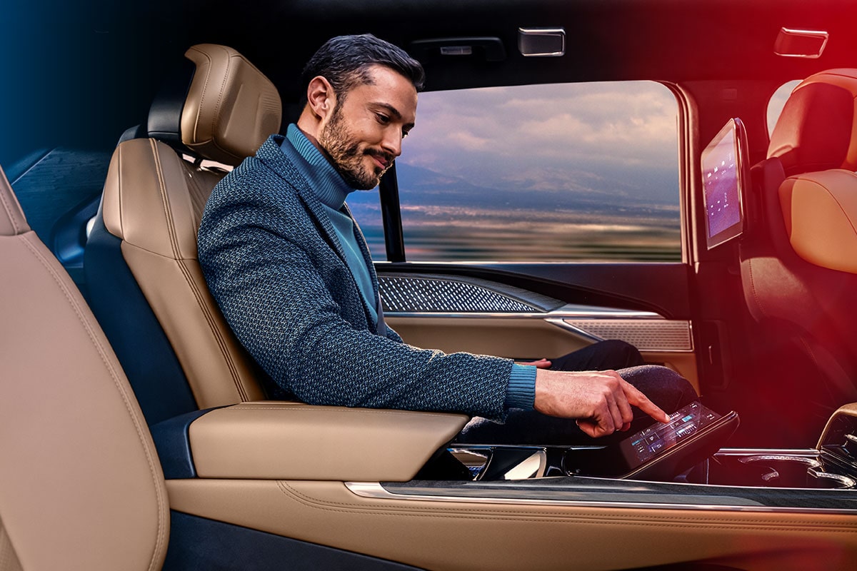 A person pressing a button in the Rear Command Centre of the 2025 Cadillac Escalade IQ electric suv.