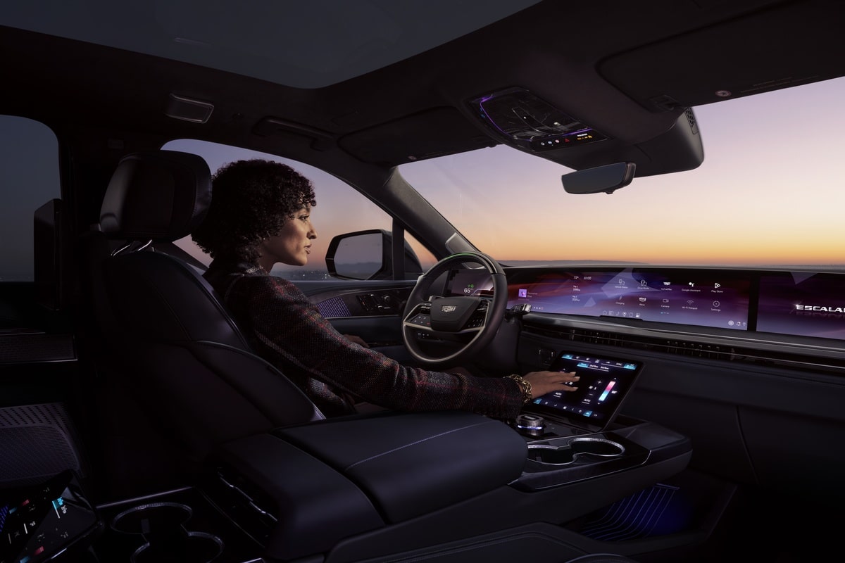 Interior view of a person driving the 2026 Cadillac Escalade IQL on the road.