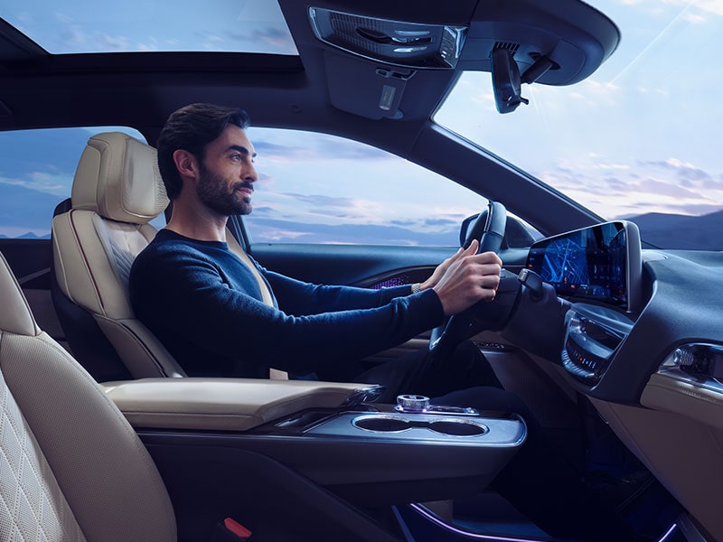 Side view of a person on the driver's seat of the 2026 Cadillac LYRIQ.