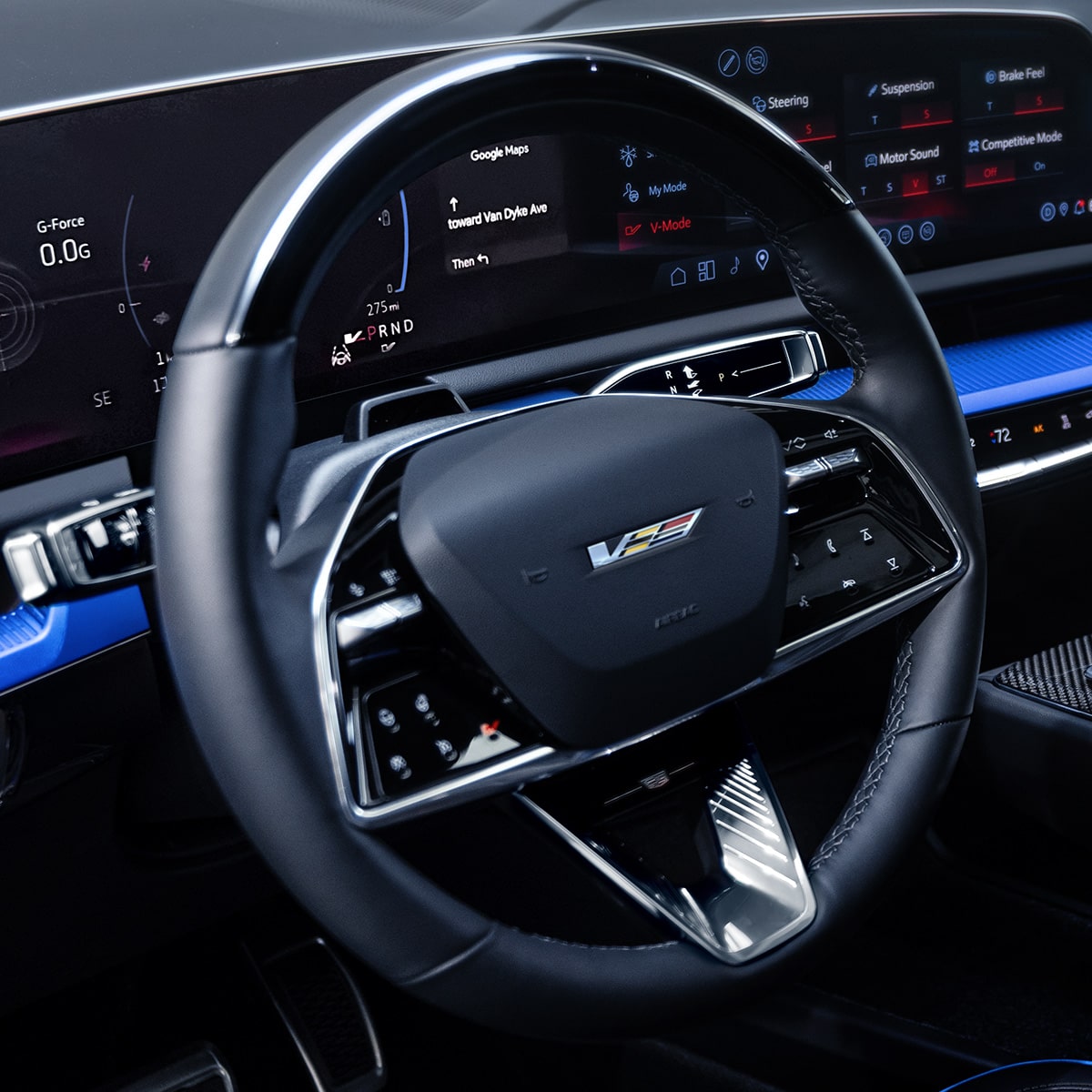 Steering wheel with Cadillac badge, paddle shifters, and illuminated controls.