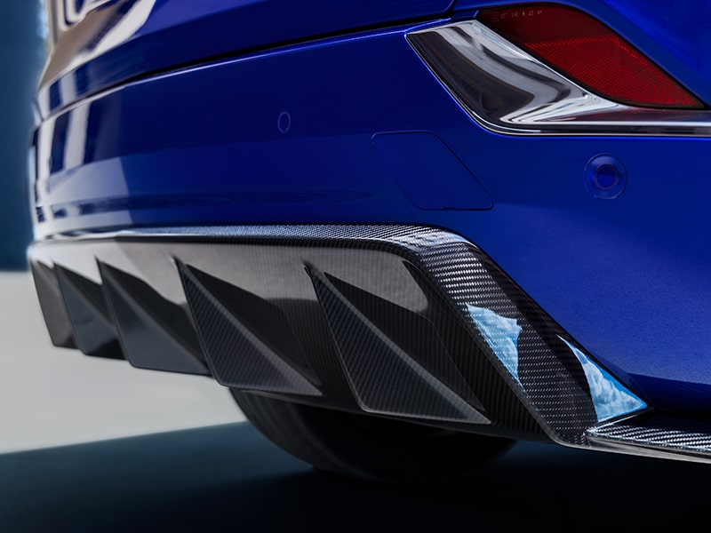 Close-up of rear diffuser and carbon fiber dual exhaust tips on the OPTIQ-V.