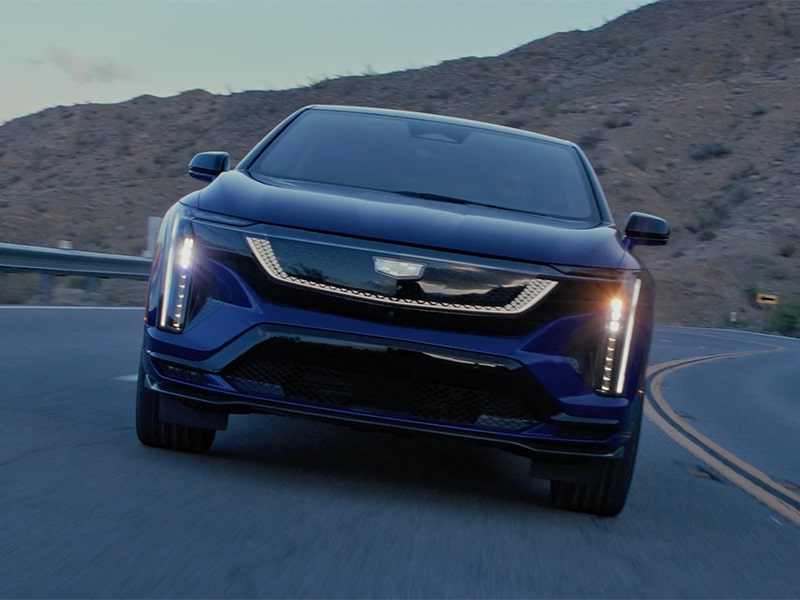 Front view of the OPTIQ-V approaching on a scenic road.