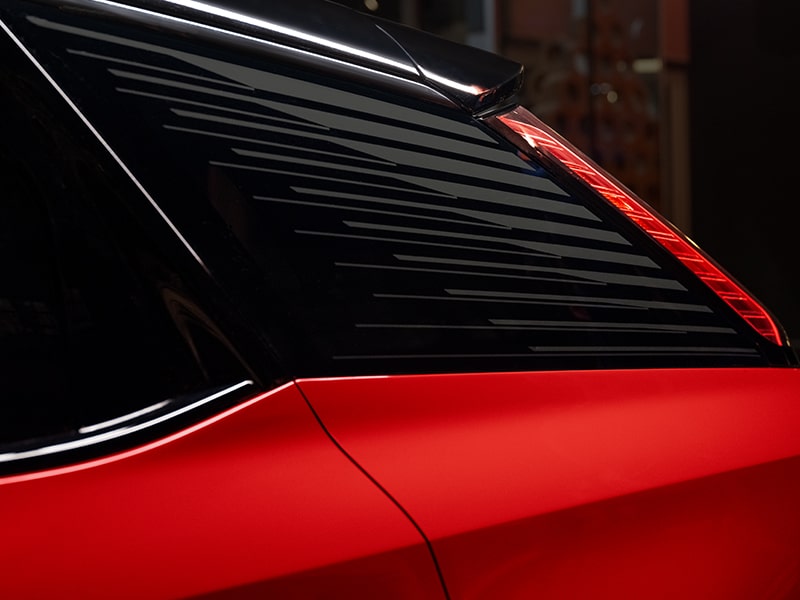 A Mondrian-patterned graphic adorning the glass of the 2026 Cadillac OPTIQ electric SUV.