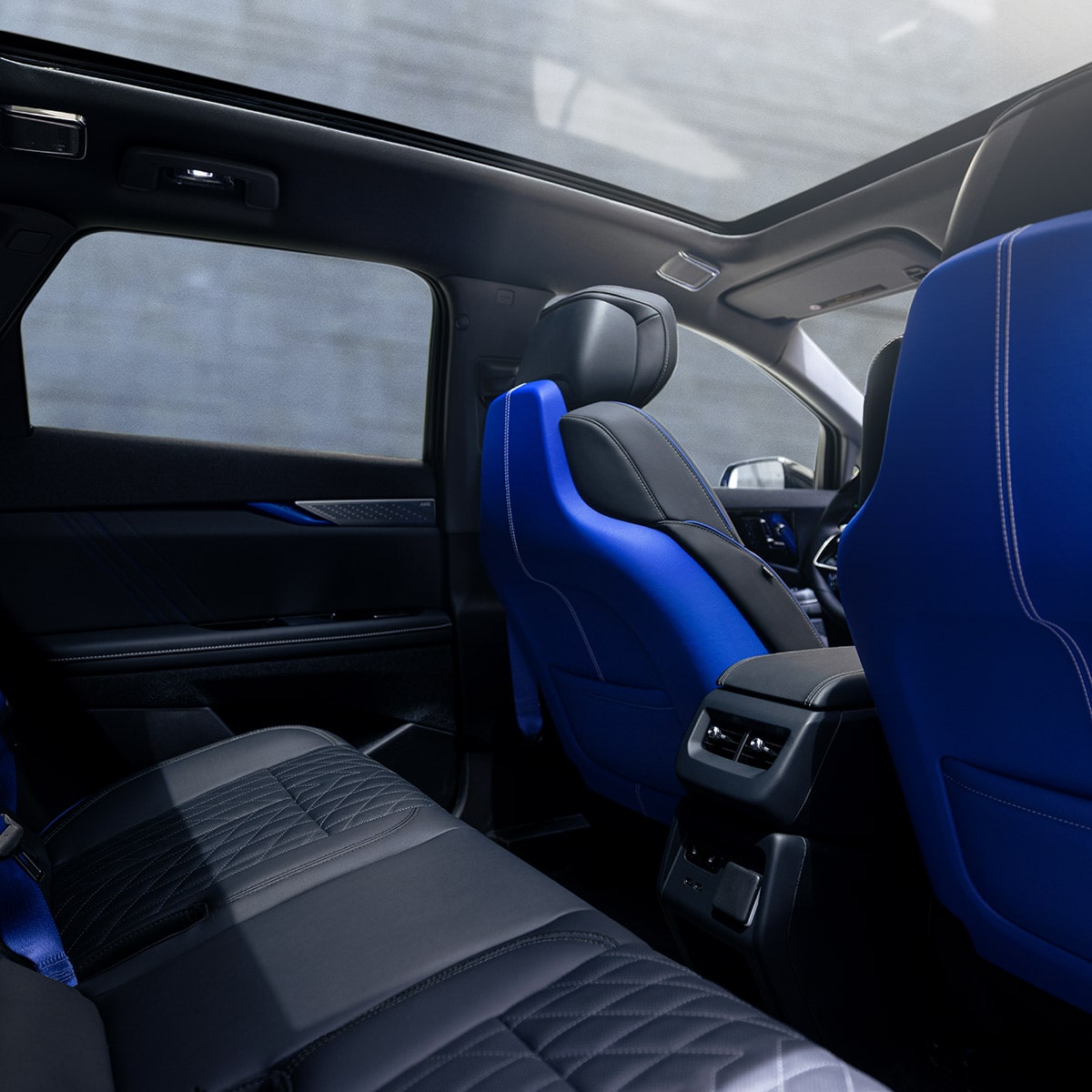 Rear seat view with blue sport bucket seats and panoramic roof.