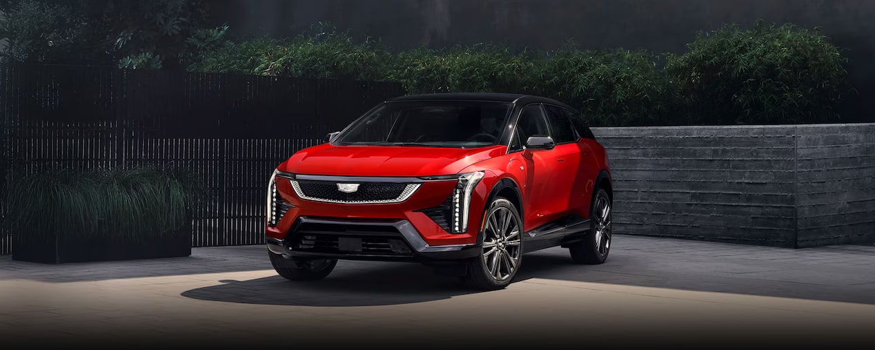 Top-side view of the 2026 Cadillac OPTIQ electric SUV alone on a city road.