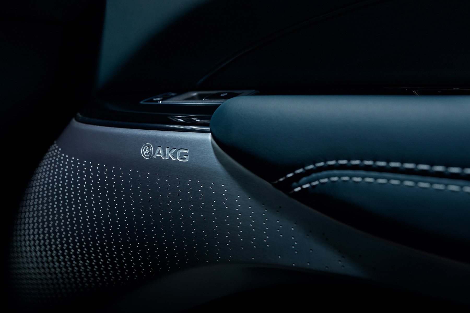 Close-up of the 2027 Cadillac LYRIQ interior door speaker featuring a premium AKG audio system.