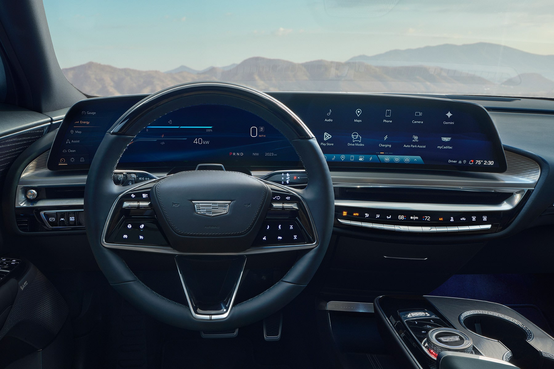 Driver’s view of the 2027 Cadillac LYRIQ interior, featuring a leather-wrapped steering wheel with the Cadillac crest and a wide curved digital display spanning the dashboard.