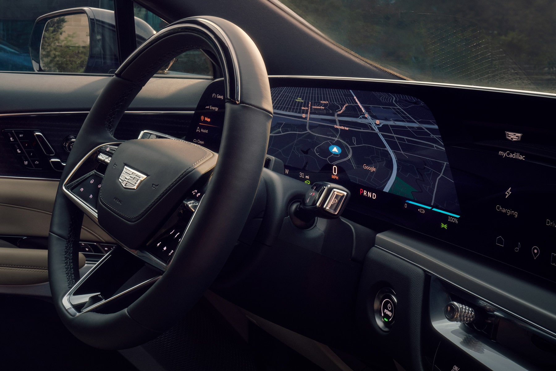 Close-up view of the 2027 Cadillac LYRIQ driver cockpit featuring a leather-wrapped steering wheel and a curved digital display.
