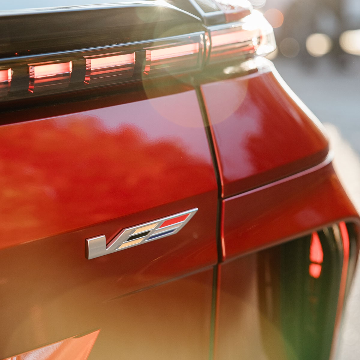 Close-up view of the V badging etched on the exterior of a 2027 Cadillac LYRIQ-V.