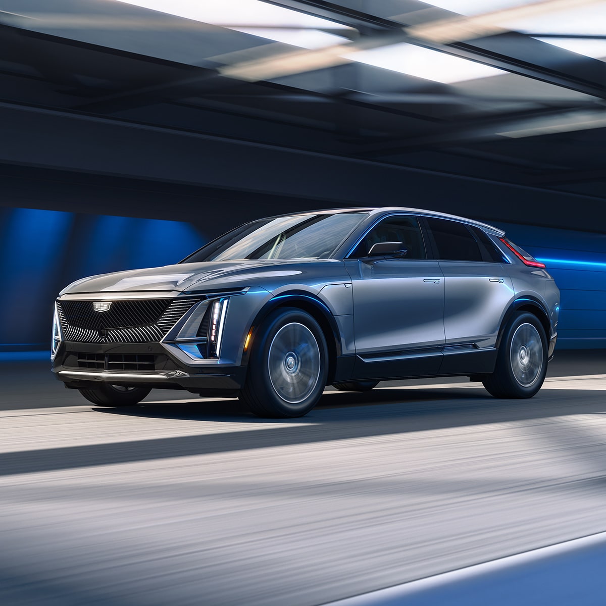 Side view of the 2027 Cadillac LYRIQ parked in a brightly lit room.