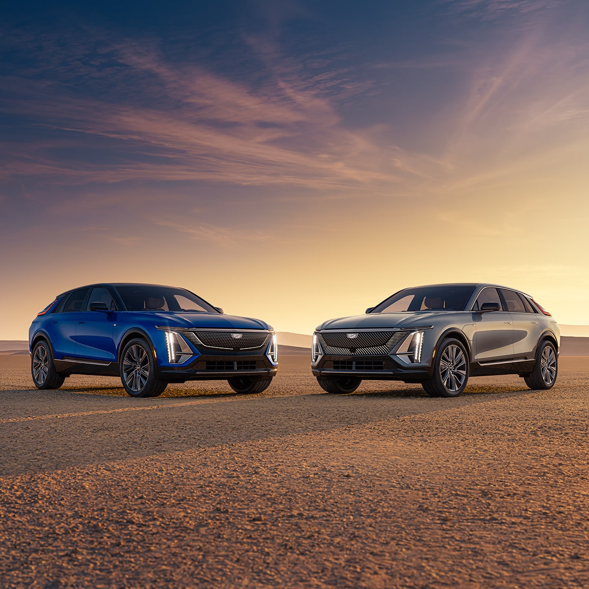 Two 2027 Cadillac LYRIQ electric SUVs parked outdoors during sunset.