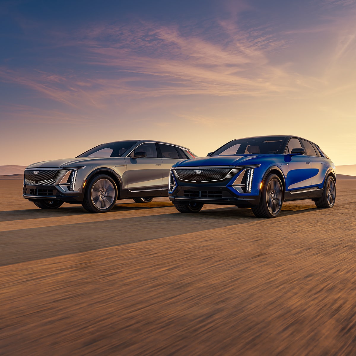 Two 2027 Cadillac LYRIQ parked near each other outdoors during sunset.