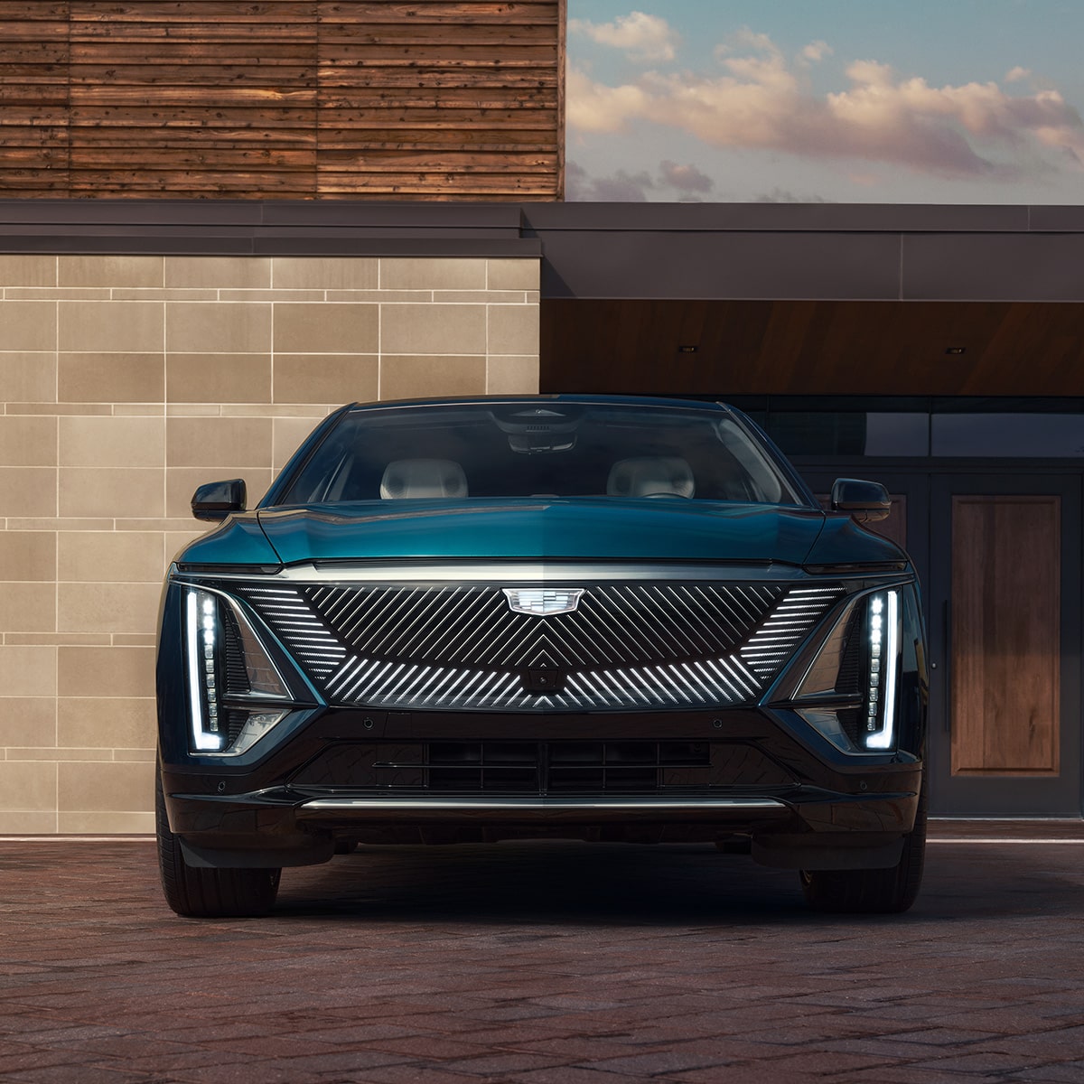 Front view of a 2027 Cadillac LYRIQ parked outside a house.