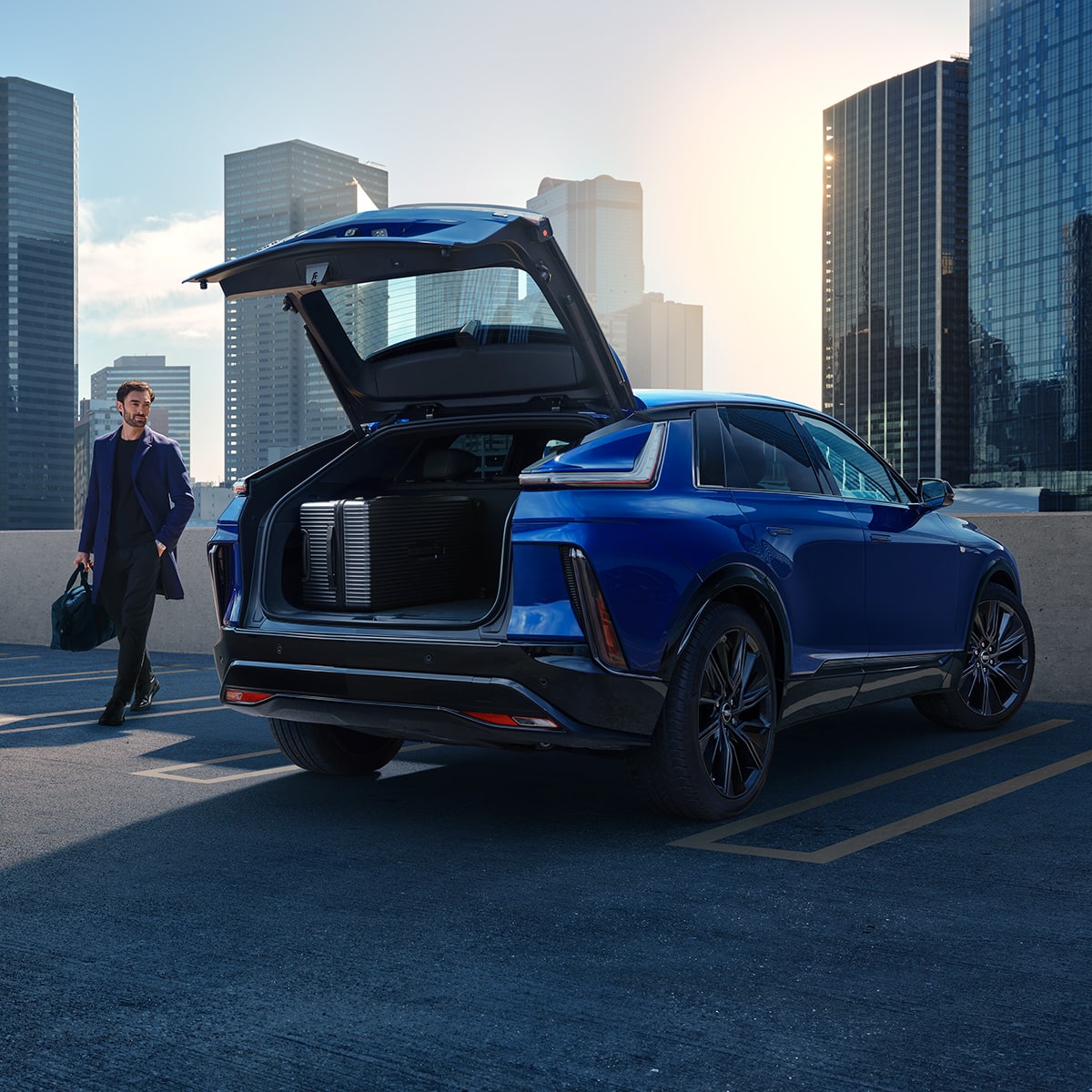 2027 Cadillac LYRIQ parked on a rooftop with its rear trunk open.