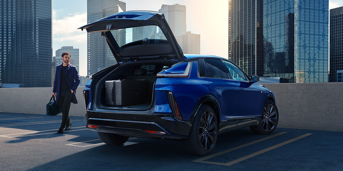 2027 Cadillac LYRIQ With the Rear Liftgate Open in an Urban Parking Area.