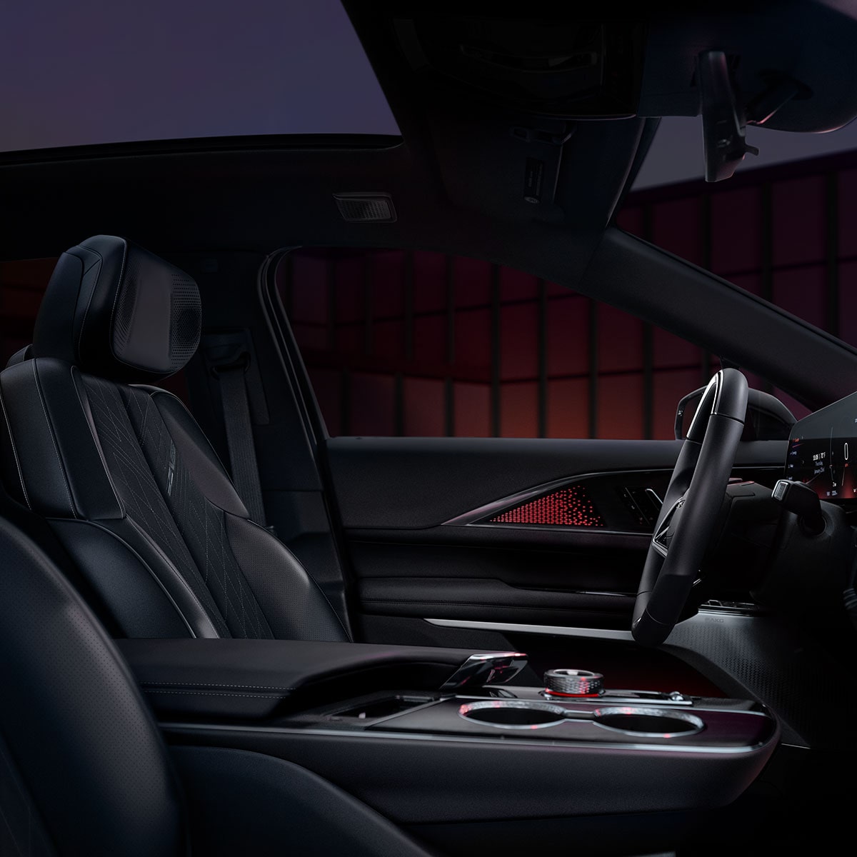 Front interiors of the 2027 Cadillac LYRIQ-V parked in a dimly-lit setting.