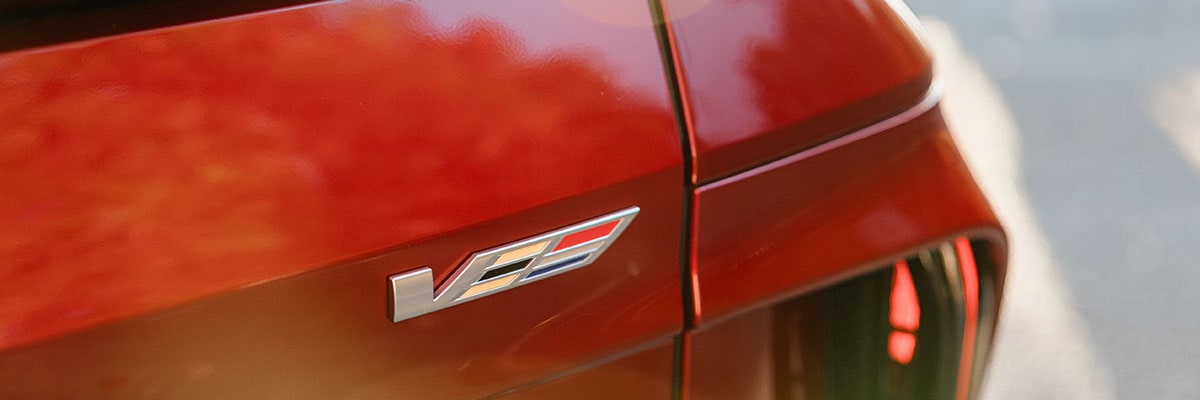 Close-up view of the V badging etched on the exteriors of the 2027 Cadillac LYRIQ-V SUV.